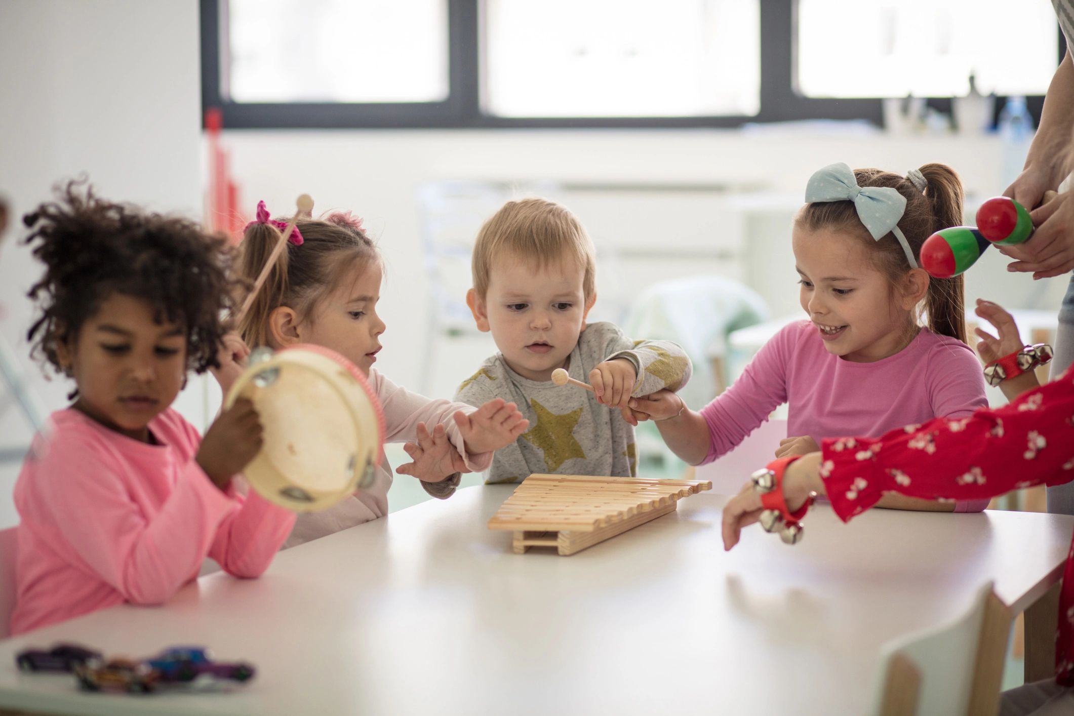 Preschool children making music together indoors