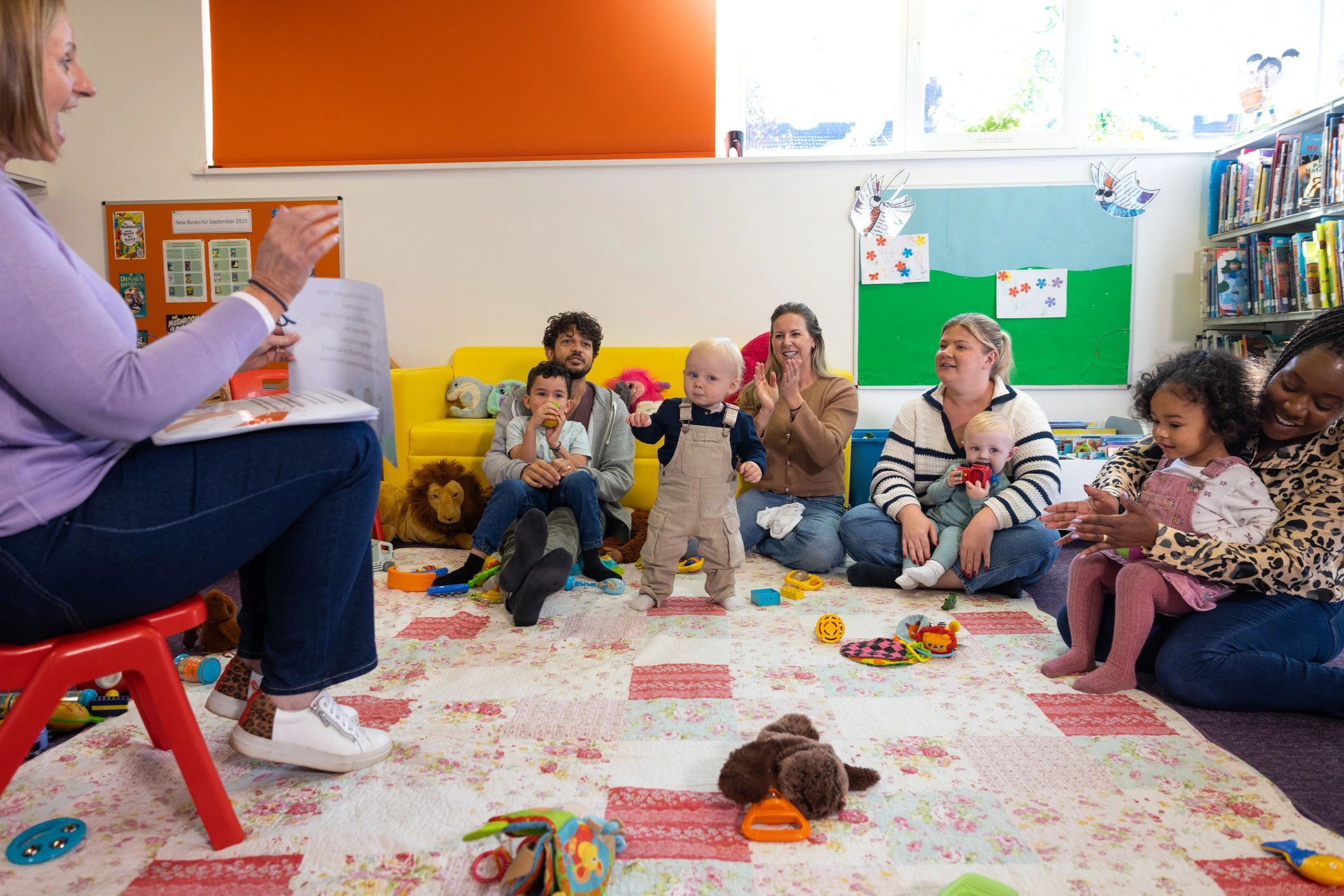 Caregiver with young children in a welcoming childcare setting
